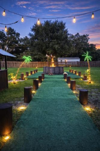 a long green pathway with lights at night at Family Country Retreat w Pool, Games & Fire Pit in Clewiston