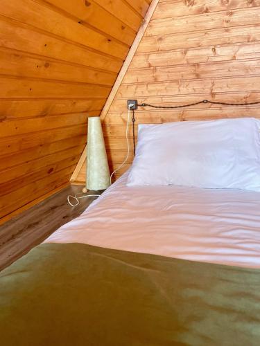 a bedroom with a bed in a wooden cabin at Yerankyun Boutique Cabin in Lermontovo