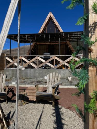 two chairs and a bench in front of a building at Yerankyun Boutique Cabin in Lermontovo