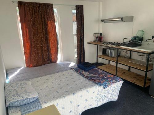 a small bedroom with a bed and a sink at Beekind in San Juan Teotihuacán