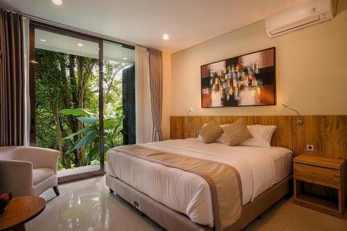 a bedroom with a bed and a large window at Wikubu Villa in Munduk