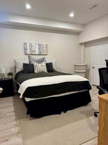 a bedroom with a large bed with pillows on it at Spacious High Ceiling Lower Level Suite-New & Cozy in Vaughan