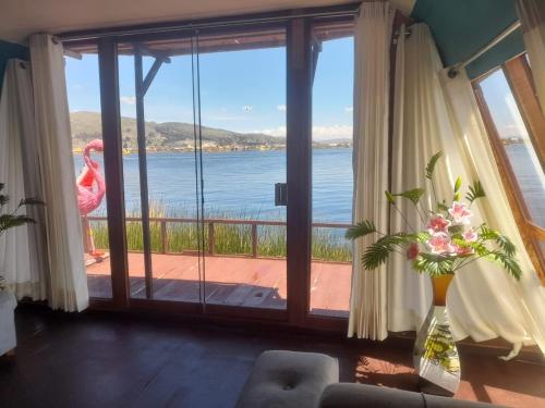 a living room with a view of the water at Suma Kusi en el Titicaca in Puno