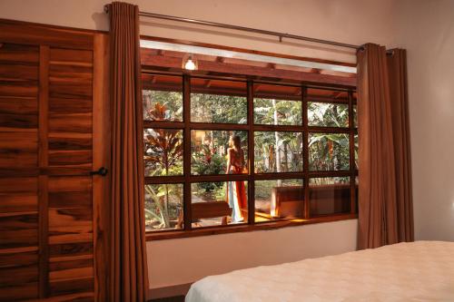 a bedroom with a window and a bed at Villa Sebastiana Bungalows in Tarapoto