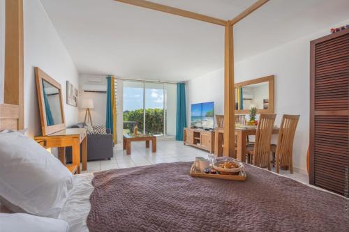 a bedroom with a bed with a tray of food on it at Orient Bay Studio SABA Face à la Mer in Cul de Sac