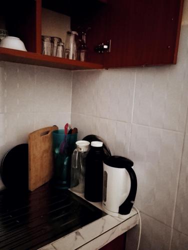 a kitchen counter with a coffee maker and bottles on it at Jipso homes in Eldoret