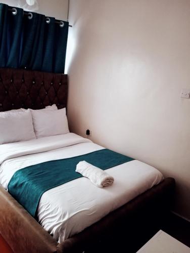 a bedroom with a bed with a towel on it at Jipso homes in Eldoret