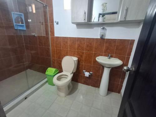 a bathroom with a toilet and a sink and a shower at Finca # 20 - Arjona in Turbaco