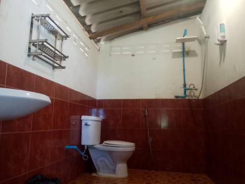 a bathroom with a toilet and a sink at Ao Siri Beach Bungalow in Ko Jum