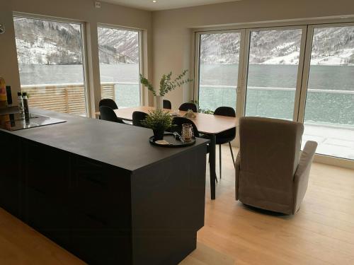 a kitchen with a table and chairs in a room at Newly Built Cabin With Sauna By Oldevatnet in Olden