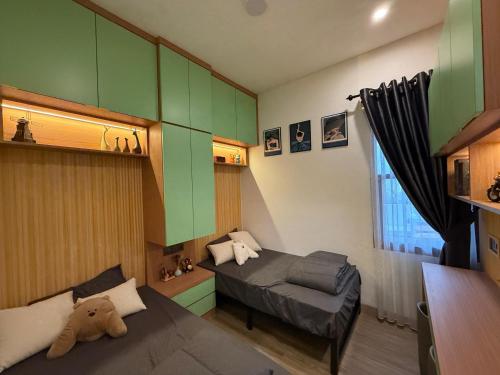a small room with a bed and a couch at Pendo Mansion in Pulau Sembakau Kecil