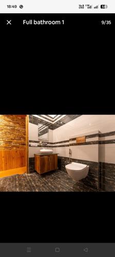 a bathroom with a sink and a bath tub at Blissful Lodge in Banjār
