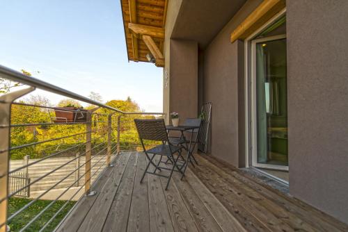 a chair sitting on a deck with a view at La Casa Di Kiki in Cuneo