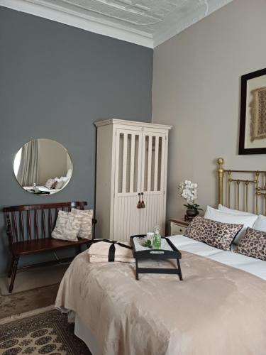 a bedroom with two beds and a mirror at Bowden B&B in Olifantshoek