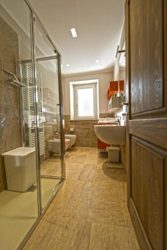 a bathroom with a shower and a toilet and a sink at La Casa Di Kiki in Cuneo