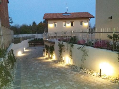 a house with lights on the side of it at La Casa Di Kiki in Cuneo