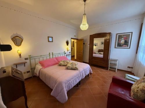 a bedroom with a large bed with pink sheets at B&B Il Pettirosso di Siena in Siena