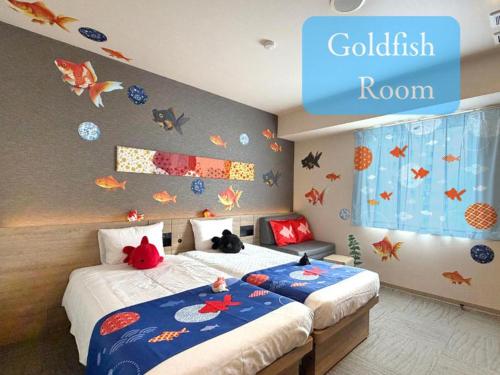 a bedroom with two beds with stuffed animals on them at Henn na Hotel Tokyo Nishikasai in Tokyo