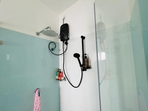 a shower in a bathroom with a shower head at Santorini VIP in Negombo