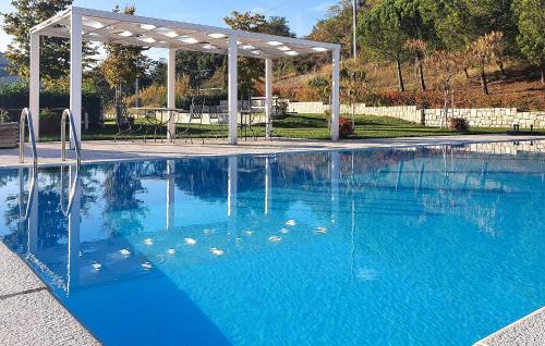 a swimming pool with a gazebo and blue water at Az Ag Ricciarelli N in San Giuliano di Puglia