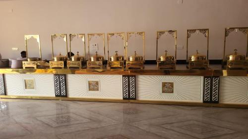a display of gold items on a table in a room at Hotel Kunj Palace in Habibnagar