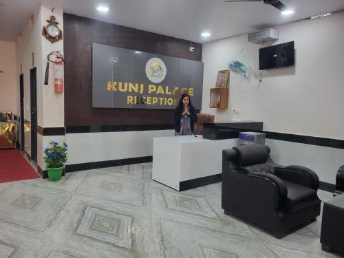 a woman standing at a podium in a hair salon at Hotel Kunj Palace in Habibnagar
