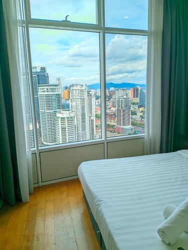 a room with a bed and a large window at vortex Suites KLCC KL in Kuala Lumpur