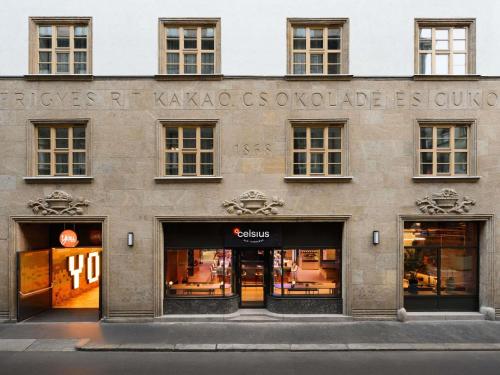 a store front of a building with windows at You Hotel Budapest - Handwritten Collection in Budapest