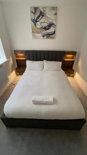 a large white bed with a white pillow on it at Blackburn House for Professionals in Blackburn