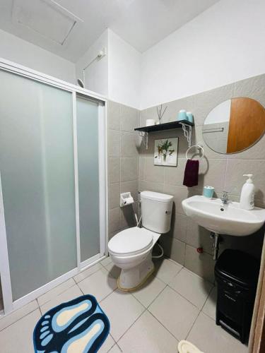 a bathroom with a shower and a toilet and a sink at Chic and Affordable Studio in Davao City