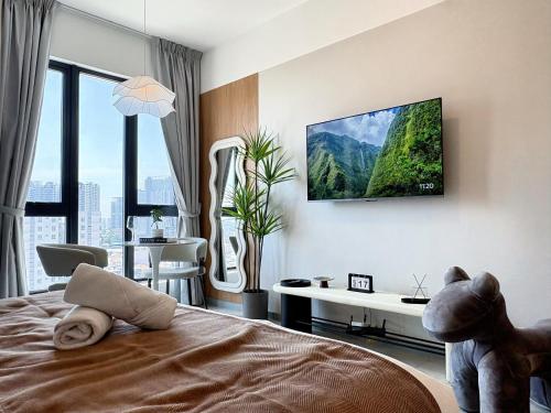 a bedroom with a teddy bear sitting on a bed at Le Arch Suite - Georgetown Komtar View Studio in George Town