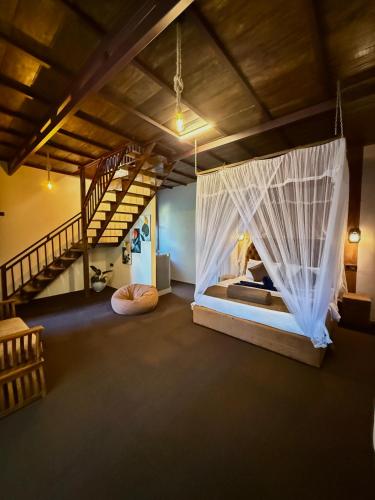 a room with a bed with mosquito net at Serene Homestay Ella in Ella