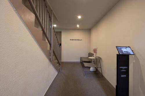 a hallway with a stairway with a sign on the wall at Parvus Sella Seongsu in Seoul