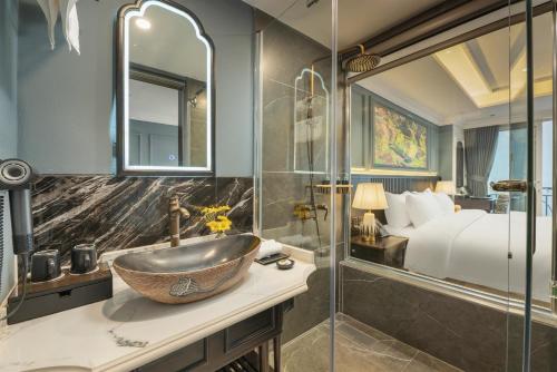 a bathroom with a sink and a bed at Sapa Horizon Hotel & Skybar in Sapa