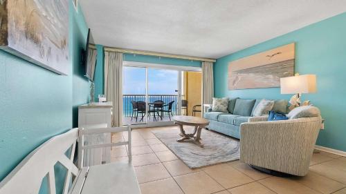 a living room with a couch and a table at Beachfront Bliss in Gulf Shores