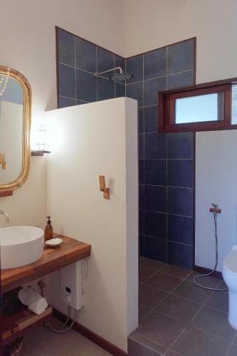 a bathroom with a sink and a mirror at Surfista Villa Siargao in General Luna