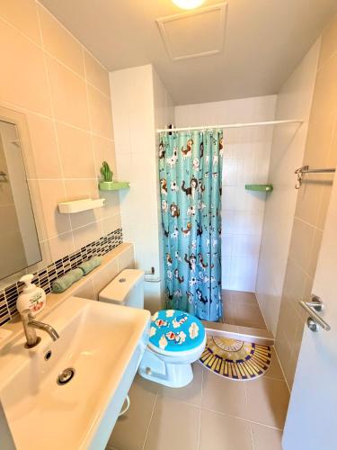 a bathroom with a sink and a toilet and a shower at Calm Home in Phuket