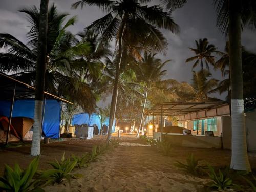 a group of tents on a beach at night at Beach vibe in Udupi