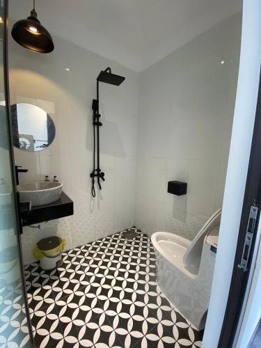 a bathroom with a tub and a sink at Nhật Quang House 2 in Danang