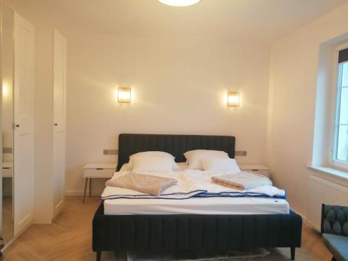 a bed with a black headboard in a room at Gemütlich & stilvoll in Tuchola