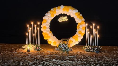 a large arch with lit candles and a wreath at Beach vibe in Udupi