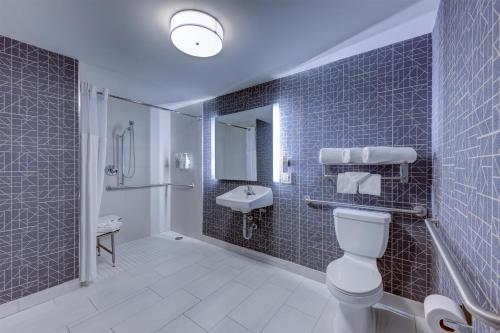 a bathroom with a toilet and a sink at Homewood Suites by Hilton-Anaheim in Anaheim