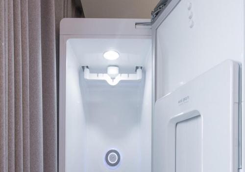 a white refrigerator with a light on top of it at Brown Dot Yeongildae Beach in Pohang in Pohang
