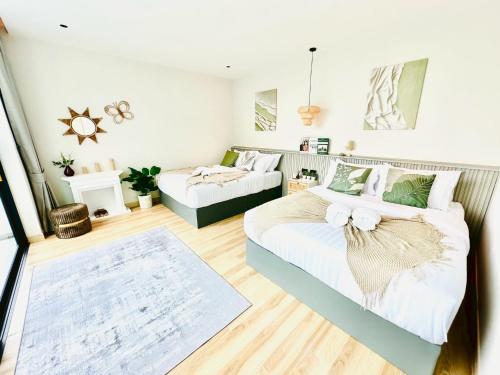 a bedroom with two beds and a couch at นารา พลูวิลล่า in Cha Am