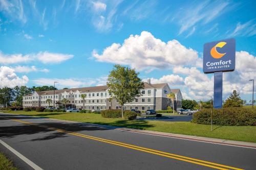a sign for a comfort inn on the side of a road at Comfort Inn & Suites Savannah Airport in Savannah