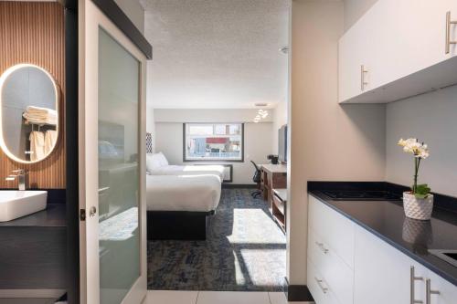 a hotel room with a bed and a bathroom at Inn The Mountains, an Ascend Collection Hotel in Hope