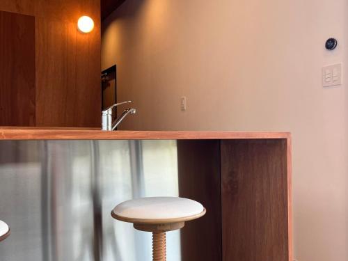 a stool sitting under a counter in a bathroom at OceansideRanch Miyazaki in Miyazaki