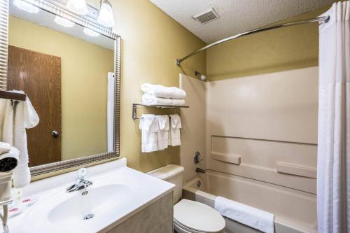 a bathroom with a sink and a toilet and a mirror at Quality Inn Scottsbluff in Scottsbluff