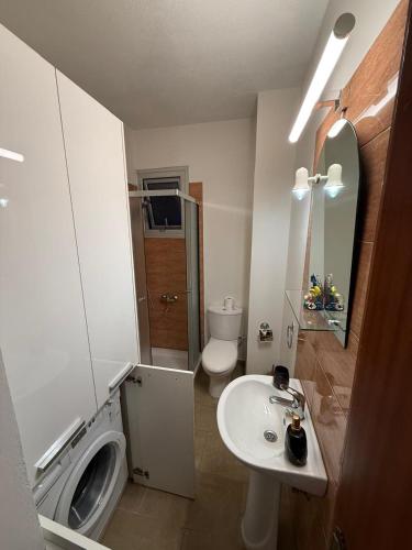 a bathroom with a sink and a washing machine at 777 Stars in Paphos