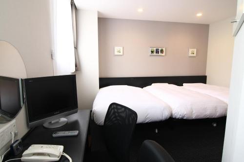 Säng eller sängar i ett rum på Hotel Crown Hills Kimitsu